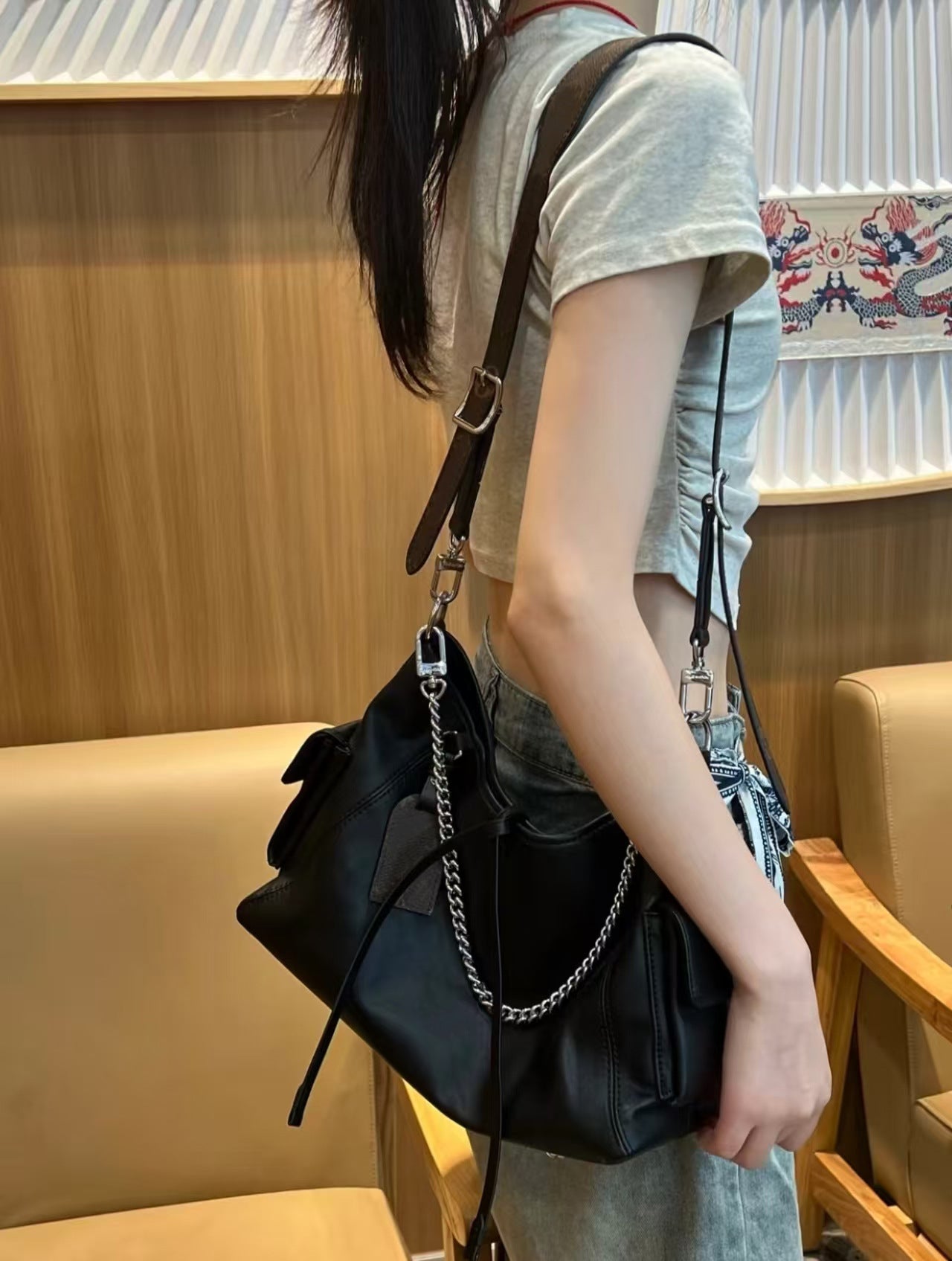 Black Leather Hobo Bag with Chain Detail | Glossy Shoulder Bag with Tassels